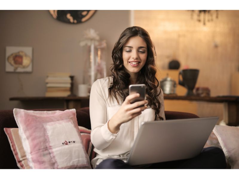 easy US online loans woman with phone and laptop