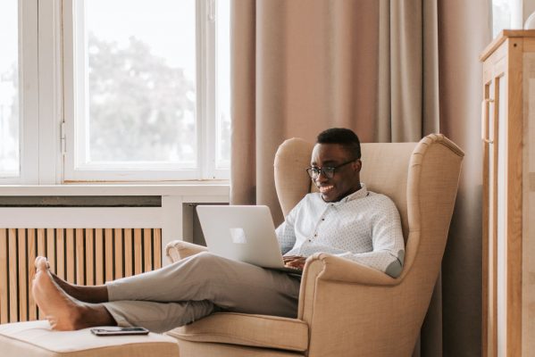 easy installment loans man in armchair with laptop