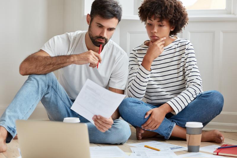 consolidating debt image of couple looking at finances