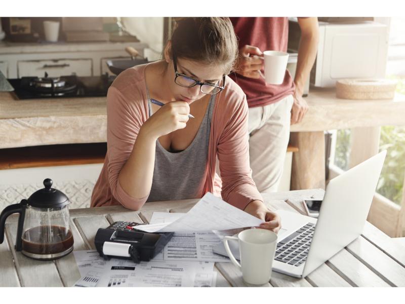 loan repayment woman pouring over paperwork