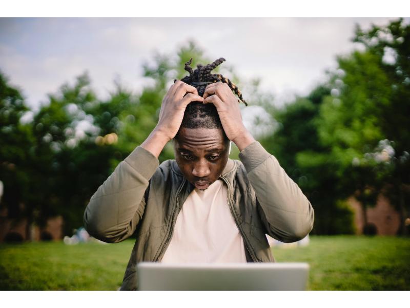 taking out a loan image of frustrated man looking at laptop