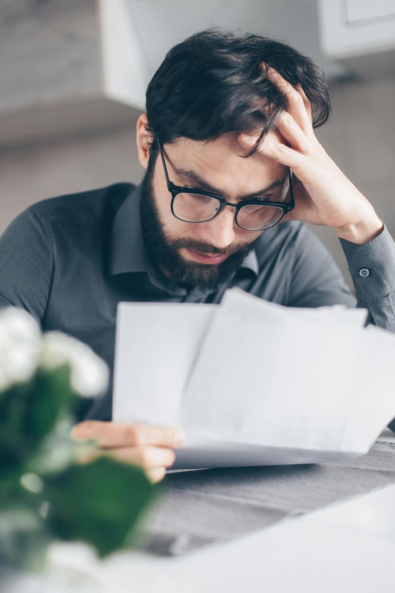 carrying debt image of man frowning at statements