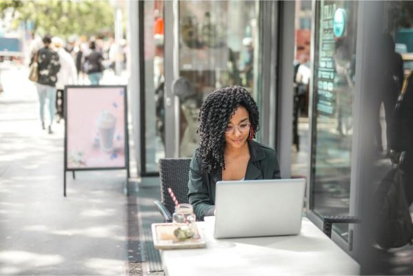 get a loan as a freelancer image of woman on laptop at cafe