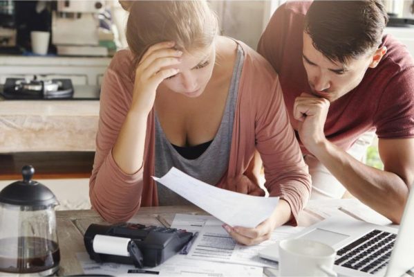 loan applicaiton mistakes image of couple frowning at paper
