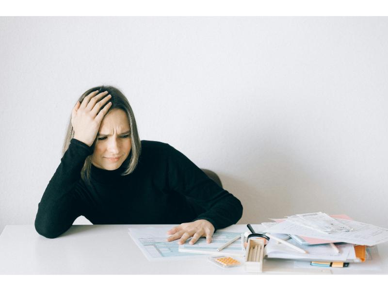 delaying debt payment woman frustrated with bills